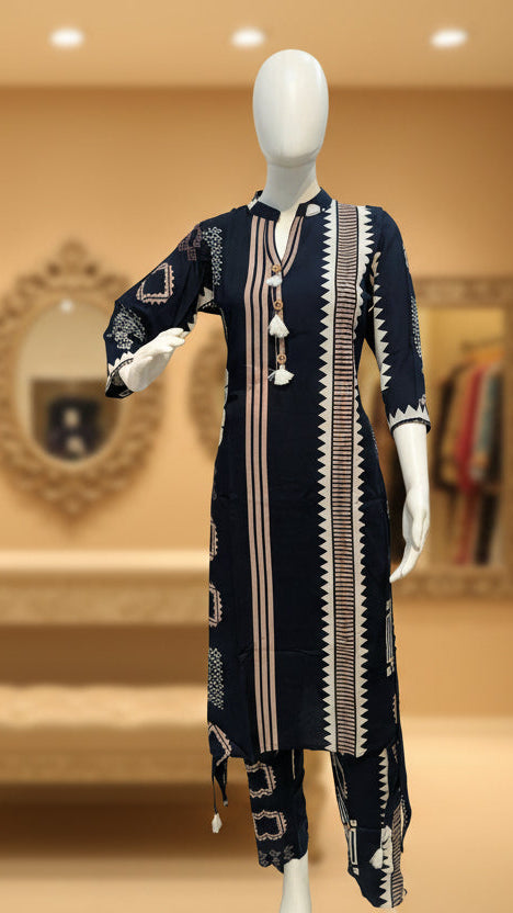 Mannequin wearing a navy blue dress with white patterns in a store setting.